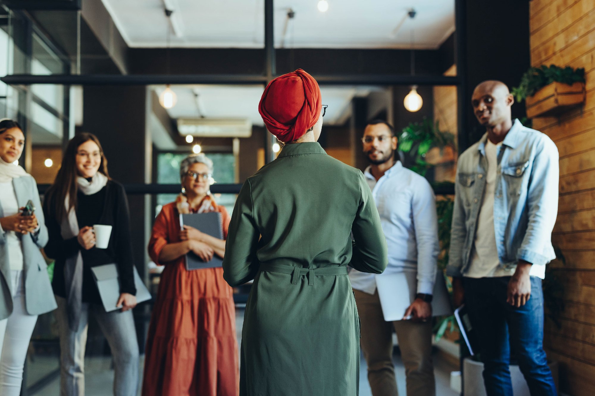 group of diverse individuals having a team meeting group of diverse individuals having a team meeting