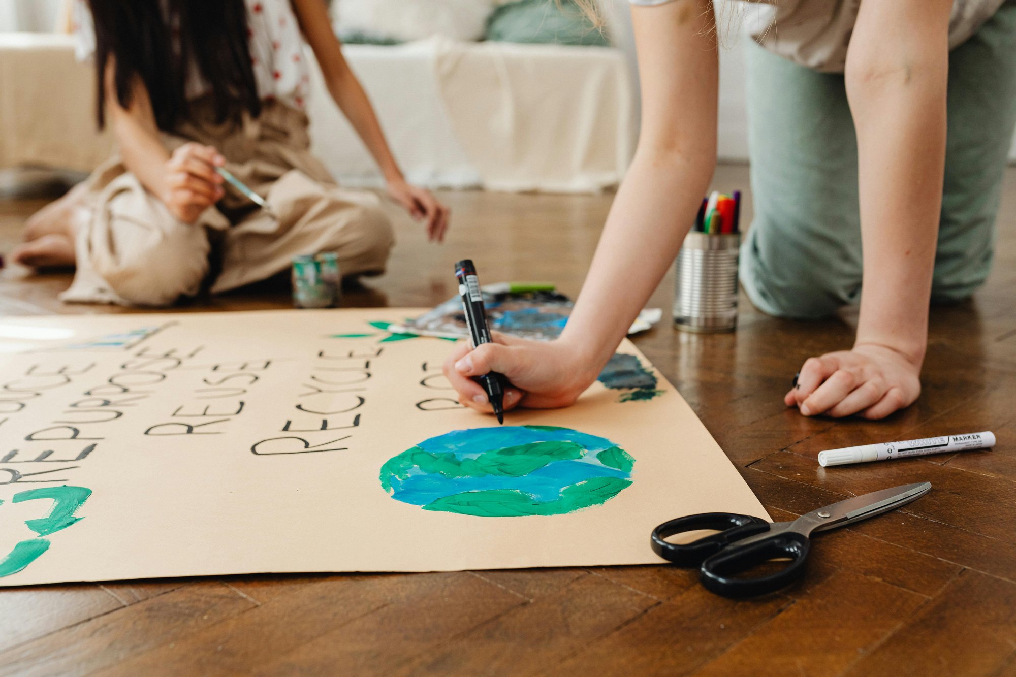 Children drawing planet - sustainability